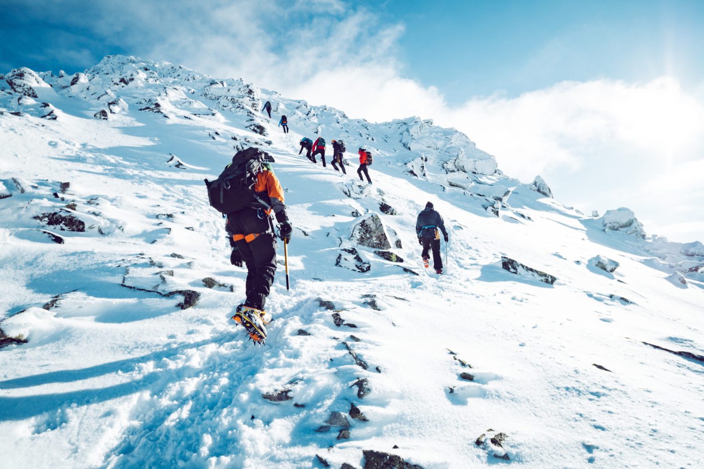 a group of people riding skis down a snow covered slope