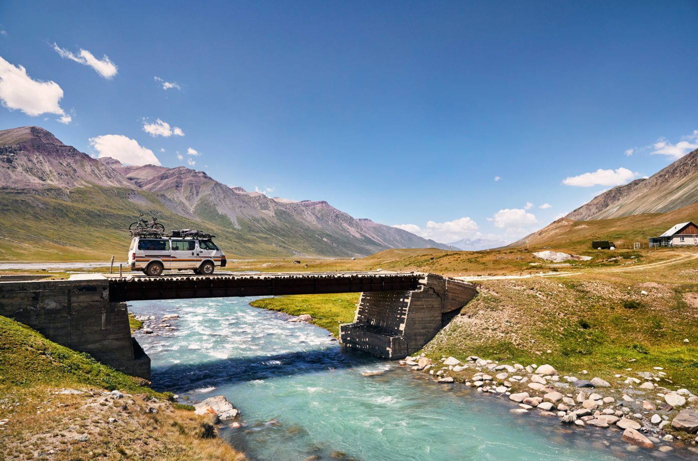 a bridge over a body of water with a mountain in the background